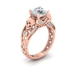 a rose gold engagement ring with an intricate design and a round diamond in the center