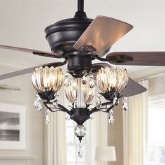 a ceiling fan with three lights hanging from it's blades in a living room