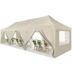 a large tent with tables and chairs under it