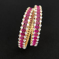 2.6 Pink Ruby Bangles/Bridal Sabyasachi Ruby Bangles/Pink Bangles/Bollywood Indian Wedding Jewelry/Indian Bangles/Bridal Bangles/CZ Bangles Features Traditional emerald studded bangles Set of 2 Handcrafted To Perfection Light Weight Perfect For Indian Weddings And Celebrations A Beautiful & Memorable Gift for Weddings and Special Occasions Size: 2.6 Made in Brass with Semi-precious stone in Pink color and CZ Stones. Jeweled Round Bangle For Wedding, Traditional Jeweled Bracelets For Weddings, Jeweled Chandbalis For Reception And Festivals, Ruby Bracelets With Stone Work For Wedding, Temple Jewelry Bracelets For Festive Receptions, Festive Celebration Round Bangle, Temple Jewelry Bangle For Diwali Party, Bollywood Style Bracelets For Diwali Reception, Temple Jewelry Style Jeweled Bangle For Wedding