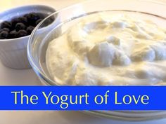 the yogurt of love is served in a bowl with blueberries next to it