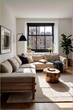 a living room filled with furniture and a large window covered in lots of windows next to a wooden coffee table