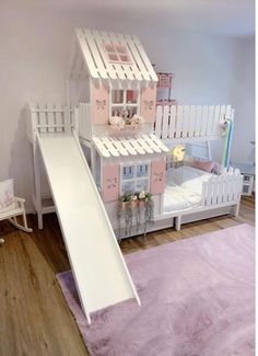 a child's bedroom with bunk beds and a slide in the middle, on top of a pink rug