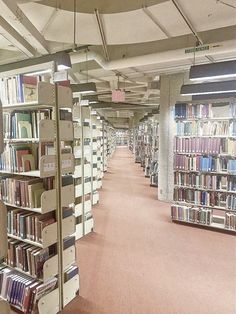 a long row of bookshelves in a library filled with lots of book cases