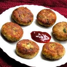 six crab cakes on a white plate with ketchup and sauce in the middle