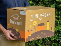 a man is holding a box that says sun basket down to no good on it