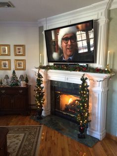 a living room filled with furniture and a flat screen tv mounted above a fire place