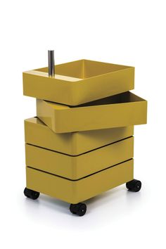 three yellow boxes stacked on top of each other with a pen sticking out of them