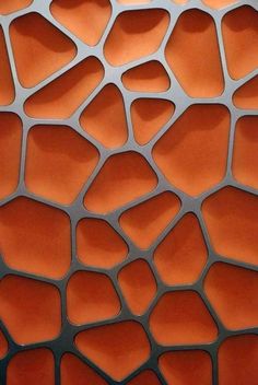 an orange and black wall with many different shapes