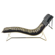 an animal print chaise lounge chair with black leather and gold metal legs, on a white background