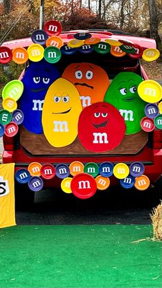 the back of a vehicle decorated with magnets and paper plates for m & m's day