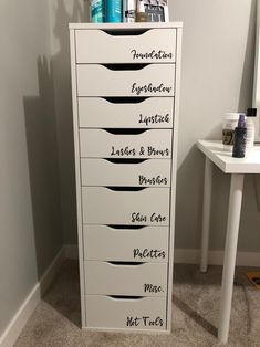 a tall white cabinet with lots of drawers