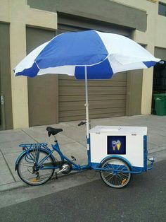 a blue and white bike with an umbrella over it