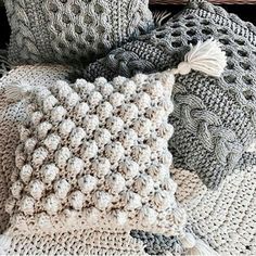 crocheted pillows and blankets sitting on top of each other