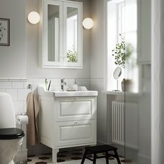 a bathroom with a sink, mirror and stool