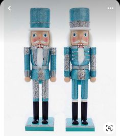 two nutcrackers are standing next to each other in blue and silver outfits