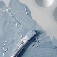 the paint is blue and white with a brush