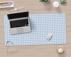 a laptop computer sitting on top of a blue and white checkered mouse pad