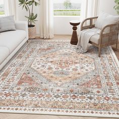 a living room with a large rug on the floor