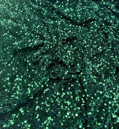 Sequin velvet This beautiful bottle green sequin dress is made from a luxurious velvet fabric that stretches slightly for comfort. The dress is 58 inches wide, equivalent to 147 cm, and is suitable for a range of apparel, upholstery, and craft projects. The dress features a stunning sequin design that adds a touch of glamour to any occasion, making it perfect for weddings, parties, and special events. The fabric is also suitable for creating drapery and upholstery for furniture, as well as beddi Luxury Green Sequin Fabric, Luxury Green Sequin Fabric For Party, Dark Green Sequin Party Dress, Green Sequin Holiday Dress, Green Sequin Dress For Holidays, Holiday Green Embellished Sequin Dress, Glamorous Green Dress With Contrast Sequin, Green Embellished Sequin Dress For Holiday, Glamorous Green Sequin Dress With Contrast