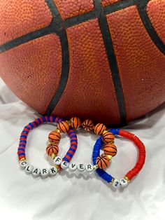 two bracelets sitting next to a basketball