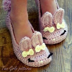 a close up of a person's feet wearing crocheted slippers with bunny ears