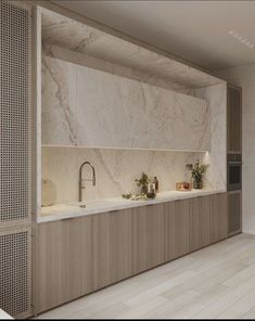 a kitchen with marble counter tops and wooden cabinets