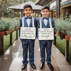 two young boys dressed in suits and bow ties holding signs that say drink, don't worry babies, just wait for the bride