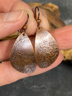 Beautifully textured, organically shaped, copper earrings.  The earrings hang from hypoallergenic rhodium ear wires.  Perfect for those casual days. Everyday Silver Copper Earrings, Rustic Copper Earrings With Ear Wire, Rustic Copper Drop Earrings, Artisan Copper Earrings For Everyday Wear, Artisan Copper Earrings For Everyday, Artisan Teardrop Copper Earrings, Artisan Copper Teardrop Earrings, Bronze Teardrop Copper Earrings, Silver Hypoallergenic Copper Earrings