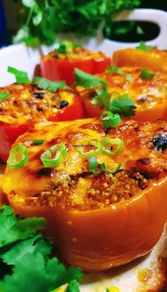 several stuffed peppers on a plate with parsley