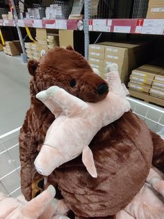 a stuffed animal in a shopping cart with other stuff animals on it's back