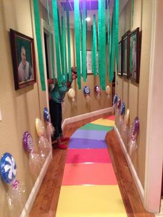 a hallway decorated with balloons and streamers