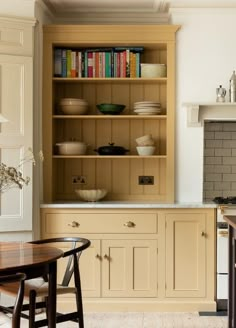 the kitchen is clean and ready to be used for cooking or dining room furniture, as well as bookshelves