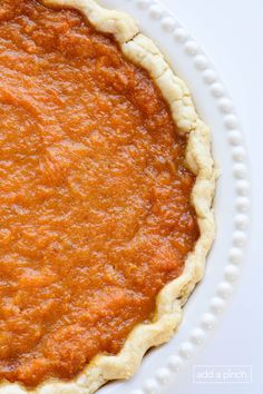 an uncooked pie sitting on top of a white plate