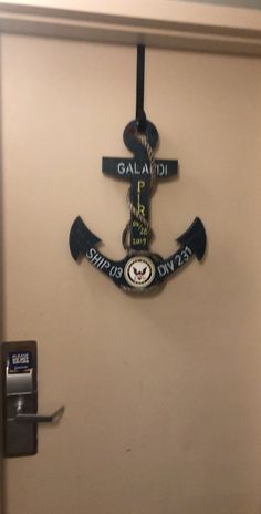 an anchor is hanging on the wall next to a door