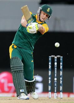 a cricket player hitting the ball with his bat