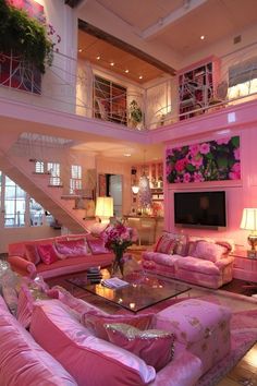 a living room filled with lots of pink furniture