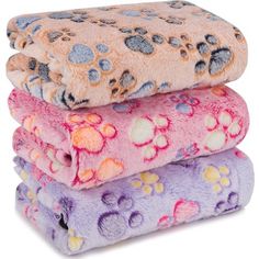 three blankets stacked on top of each other with paw prints and hearts all over them