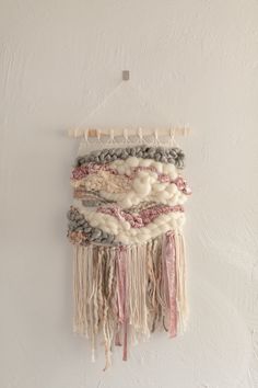 a wall hanging made with yarn and beads