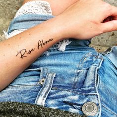 a person with a small tattoo on their arm that says, keep above the knee