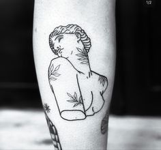 a black and white photo of a person's leg with a tattoo on it