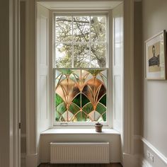 an image of a window that is in the middle of a room with wood flooring