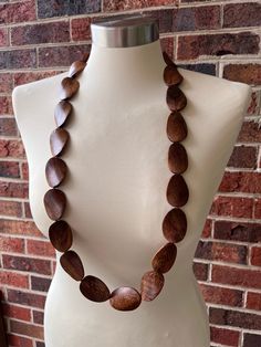 One long strand of dark brown wood beads with brown glass spacer beads. The wood color may vary from what you see on the screen due to the nature of wood. - Length is 38" (can vary depending on the beads) - Beads measure 1.5" by 1"- Lead free pewter toggle (gold toggle and stainless steel clasp also available) The necklace length can be customized. The mannequin's neck size is 14.5”. Matching earrings: https://www.danaleblanc.com/products/brown-wood-big-large-statement-dangle-earrings-miranda?_p Boho Statement Necklace, Silver Jewelry Box, Wood Necklace, Bohemian Necklace, Wood Color, Wood Jewellery, Brown Wood, Necklace Length, Wood Beads