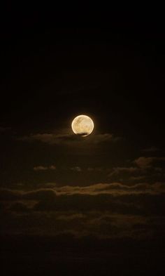 the moon is shining brightly in the dark night sky with some clouds around it and there is no image to provide a caption for