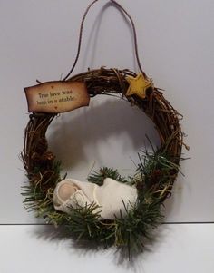 a nativity wreath with a star hanging from it