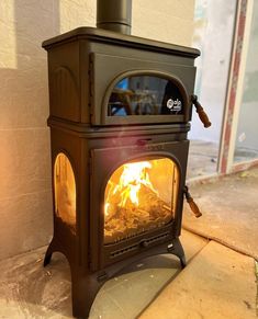 a wood burning stove sitting on top of a cement floor