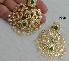 ✨🌟 Featuring a pair of gold plated HYDERABADI JADAU CHADBALI earrings studded with kundan polki, pearls, and navratna stones, set in copper. Perfect for festive occasions. 🌼🌟 Also comes in 3 color combinations: red, green, and multi-color. Elegant Chandbalis With Cutdana For Designer Wear, Bollywood Style Chandbali Earrings For Designer Wear, Designer Chandbalis With Tilla For Diwali, Designer Tilla Chandbalis For Diwali, Elegant Designer Chandbalis For Festivals, Elegant Chandbalis For Festivals, Gold Chandbali Danglers For Designer Wear, Gold Chandbali Jhumkas For Designer Wear, Elegant Designer Chandbali Jhumkas