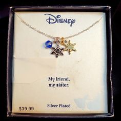 the disney necklace is in its box and it says, my friend, my sister