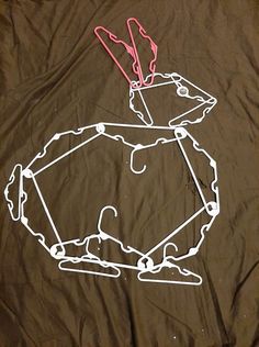 a t - shirt that has been drawn on the ground with scissors and string attached to it