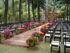 an outdoor ceremony setup with chairs and flowers